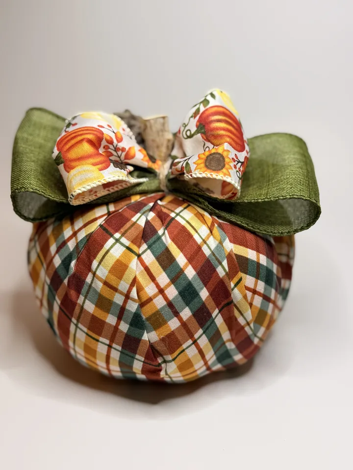 Plaid fabric pumpkin in rust, olive, mustard, and cream with layered olive and pumpkin-print ribbon bows.